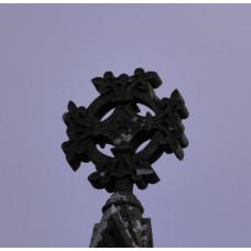 Flowery solar disc on steeple with fleur-de-lis on tips